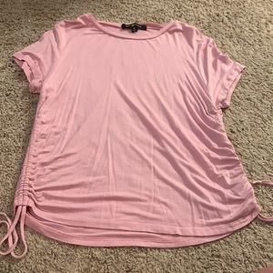 pink top size medium has adjusting things on the side